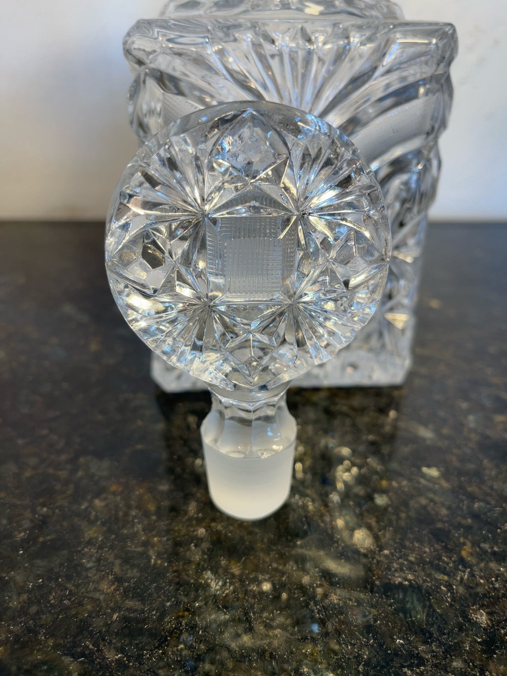Close-up view of the starburst crystal stopper and decanter neck