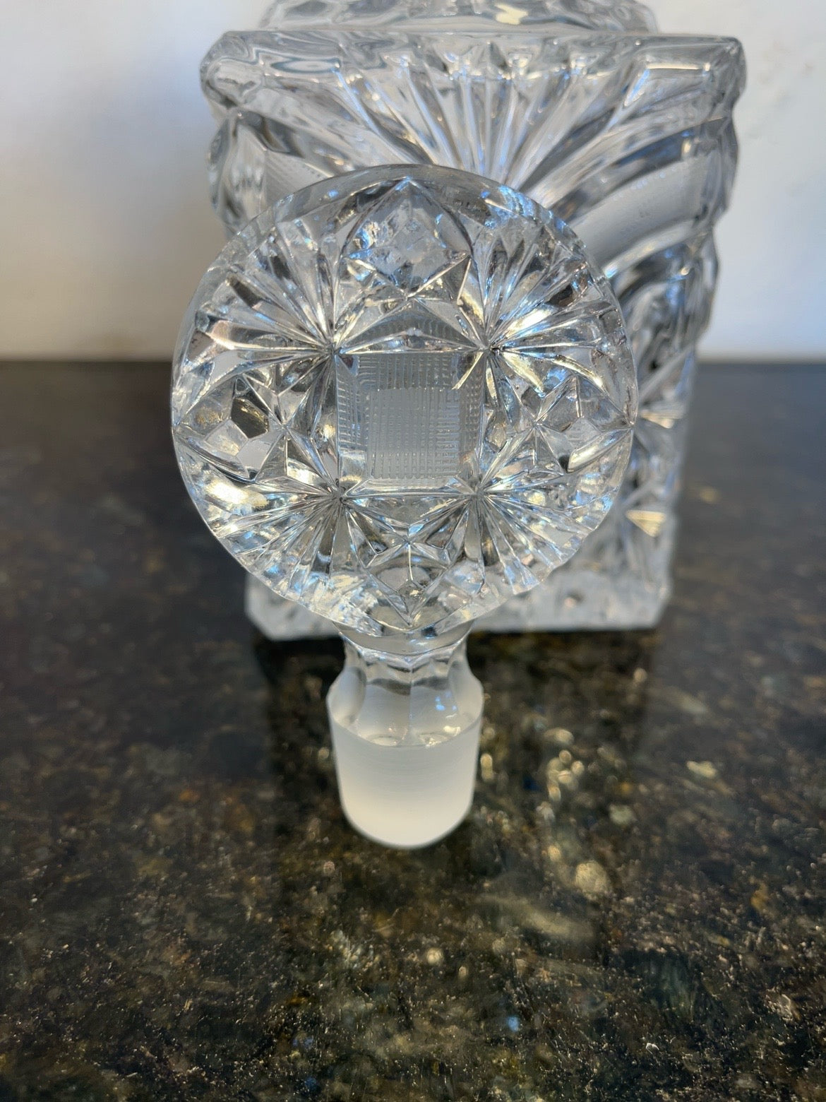 Close-up view of the starburst crystal stopper and decanter neck