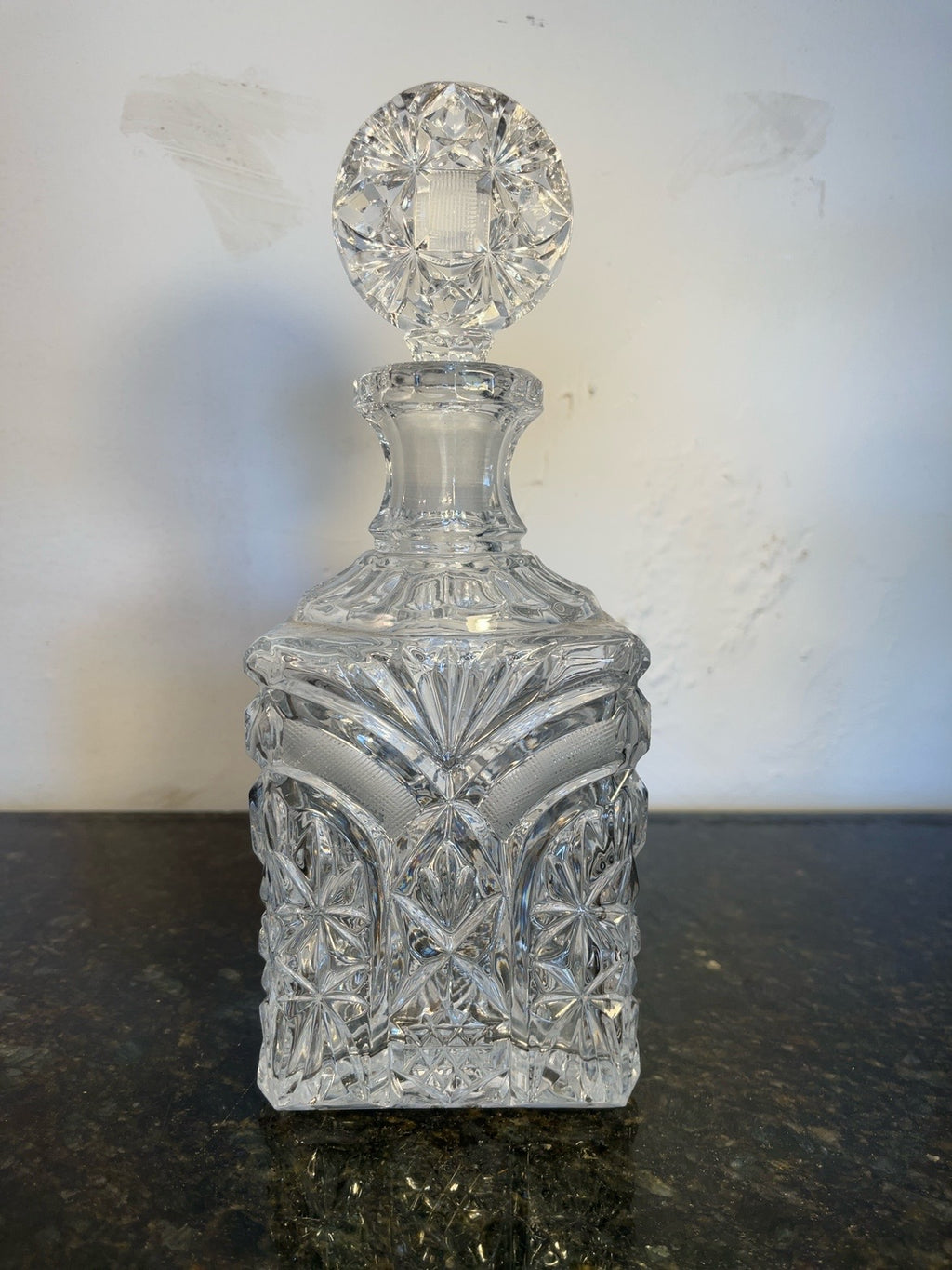 Cut crystal starburst decanter with faceted stopper, full front view