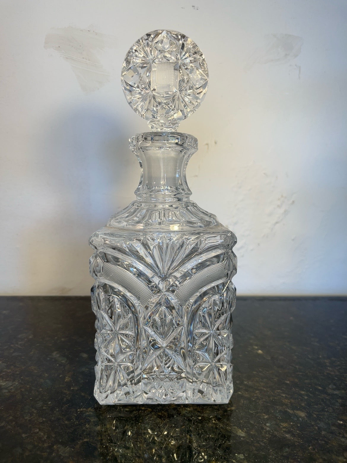 Cut crystal starburst decanter with faceted stopper, full front view
