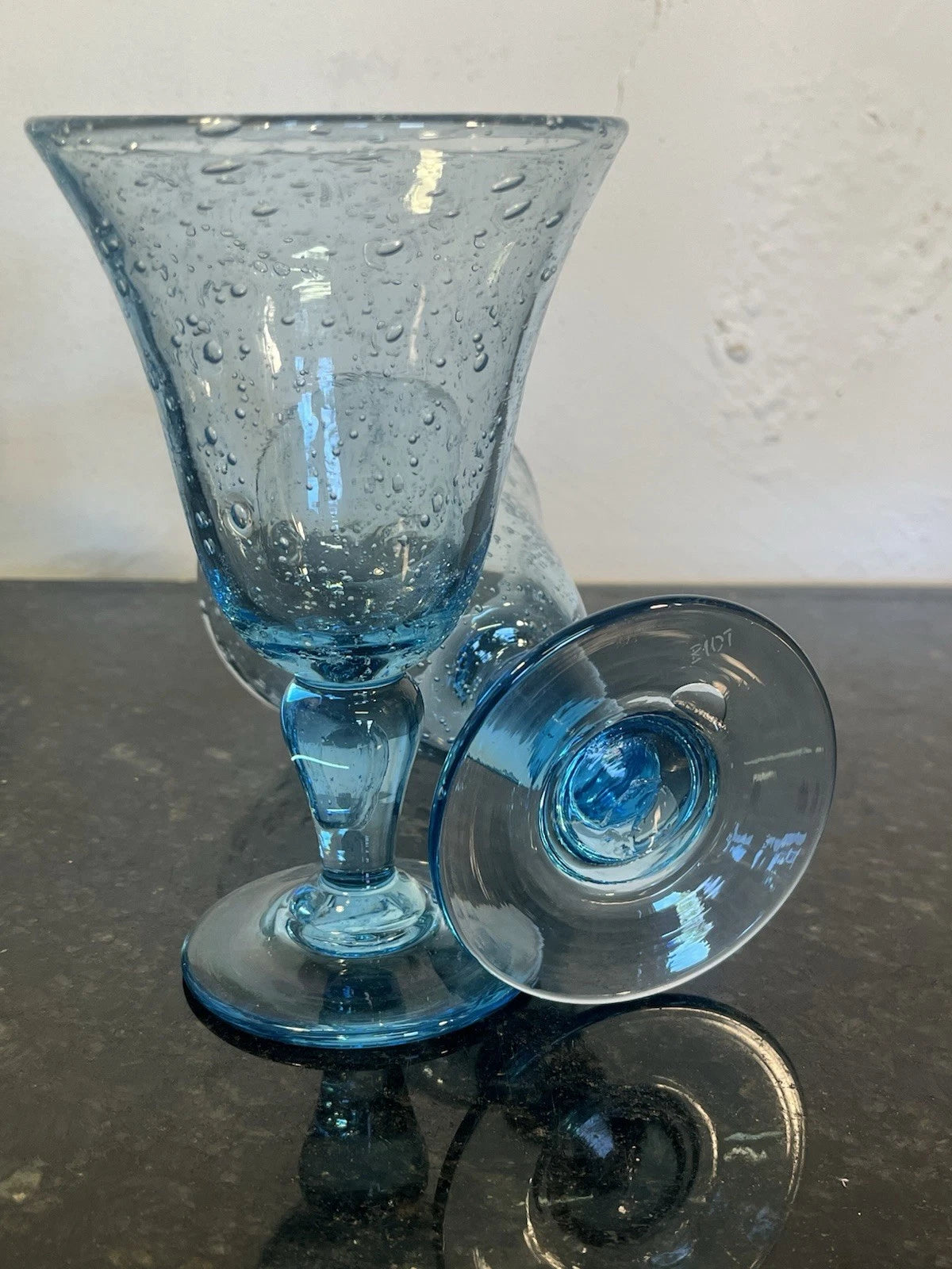 Side view showing the shape and blue glass of the Biot wine goblet pair