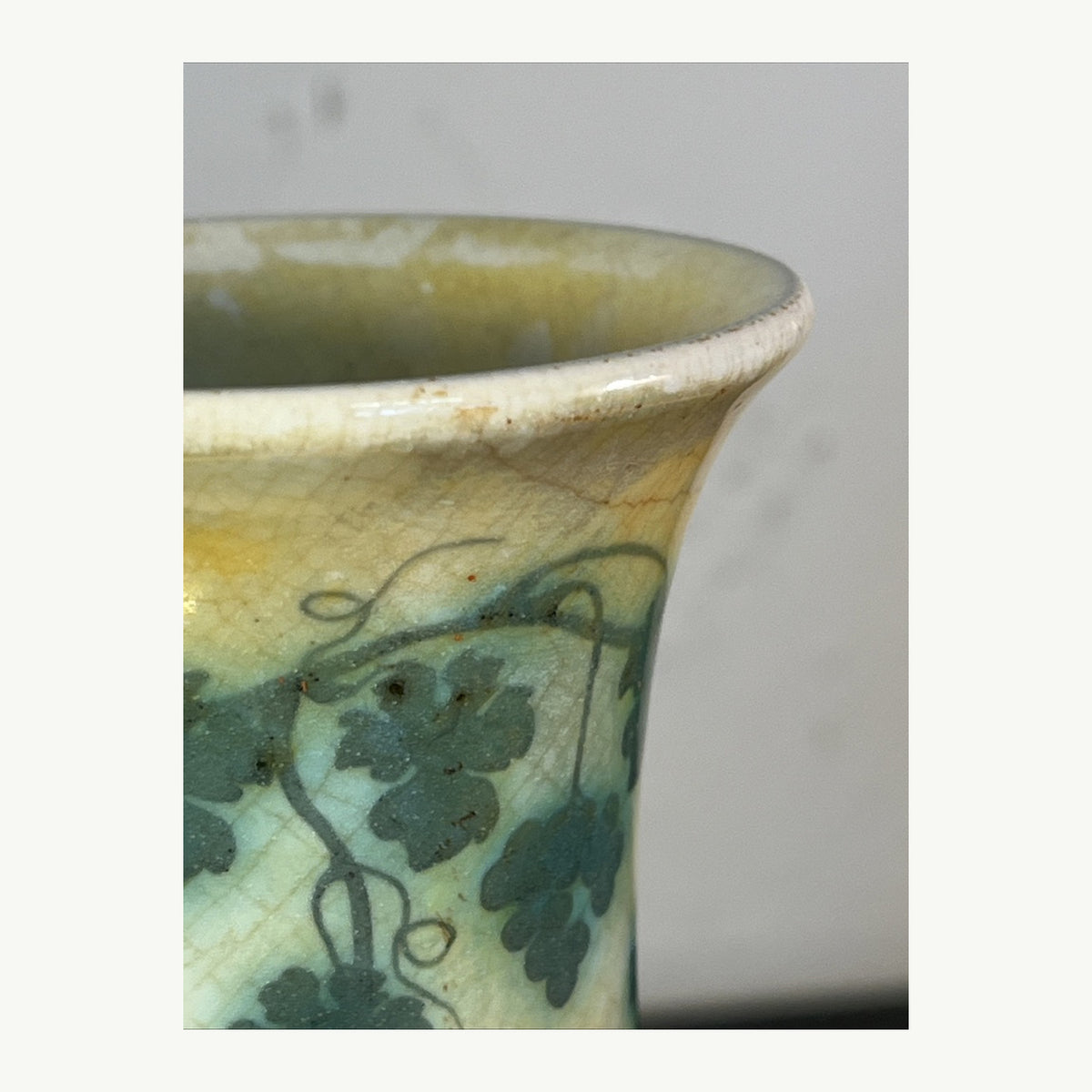 Close-up of rim and grapevine decoration on Ruskin Pottery 1909 vase