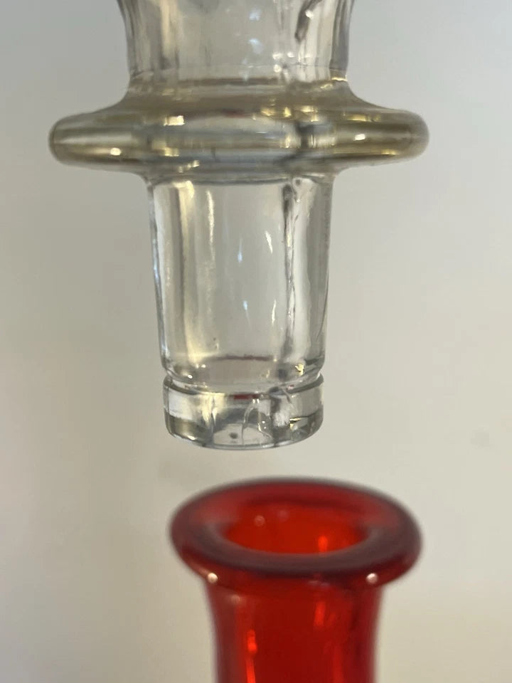 Detail view of the hand-blown ruby red optic glass bottle