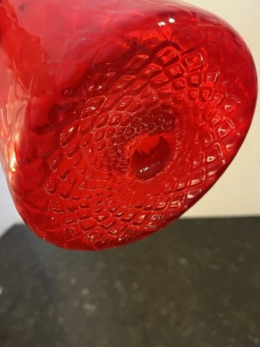 Close-up detail of the ruby red glass and pontil