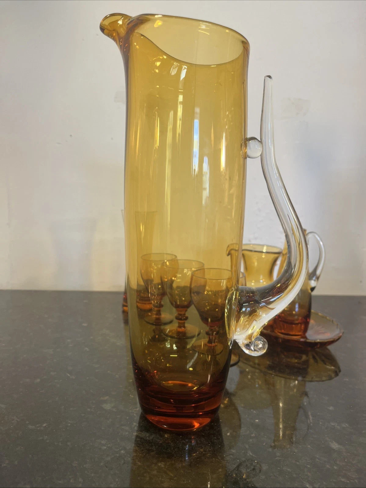 Full-height view of the tall amber glass jug with clear handle