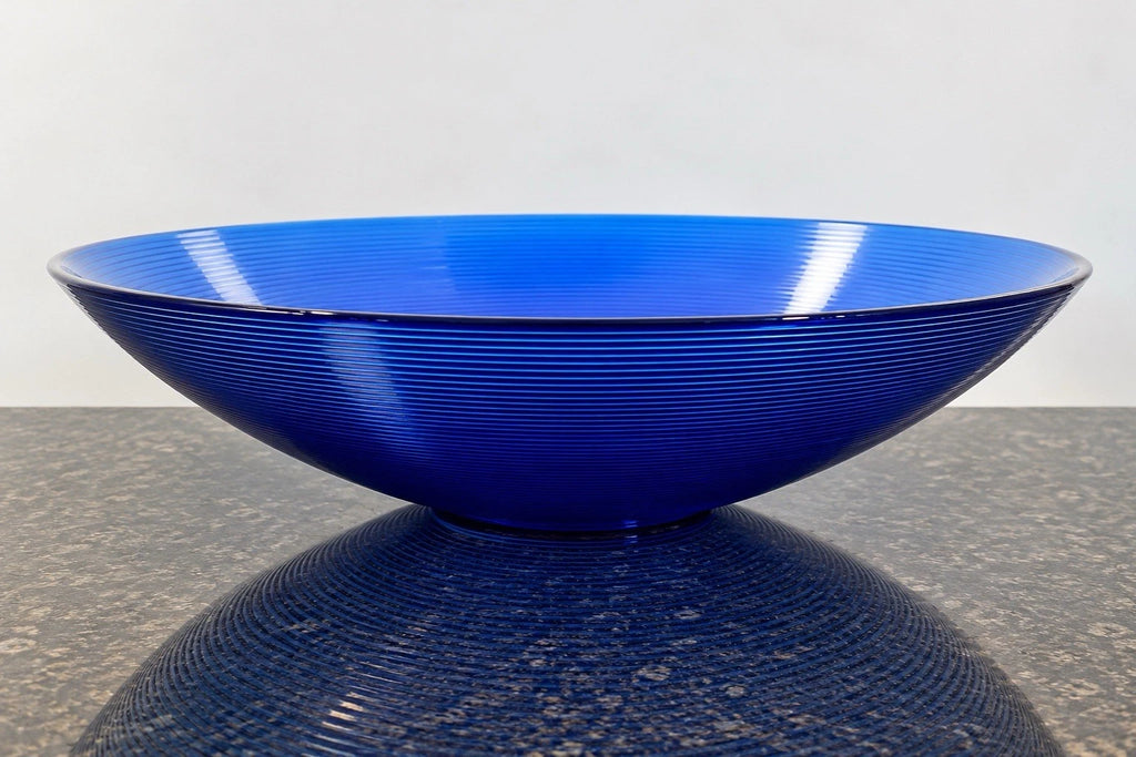 Full view of the large cobalt blue horizontally ribbed art glass bowl