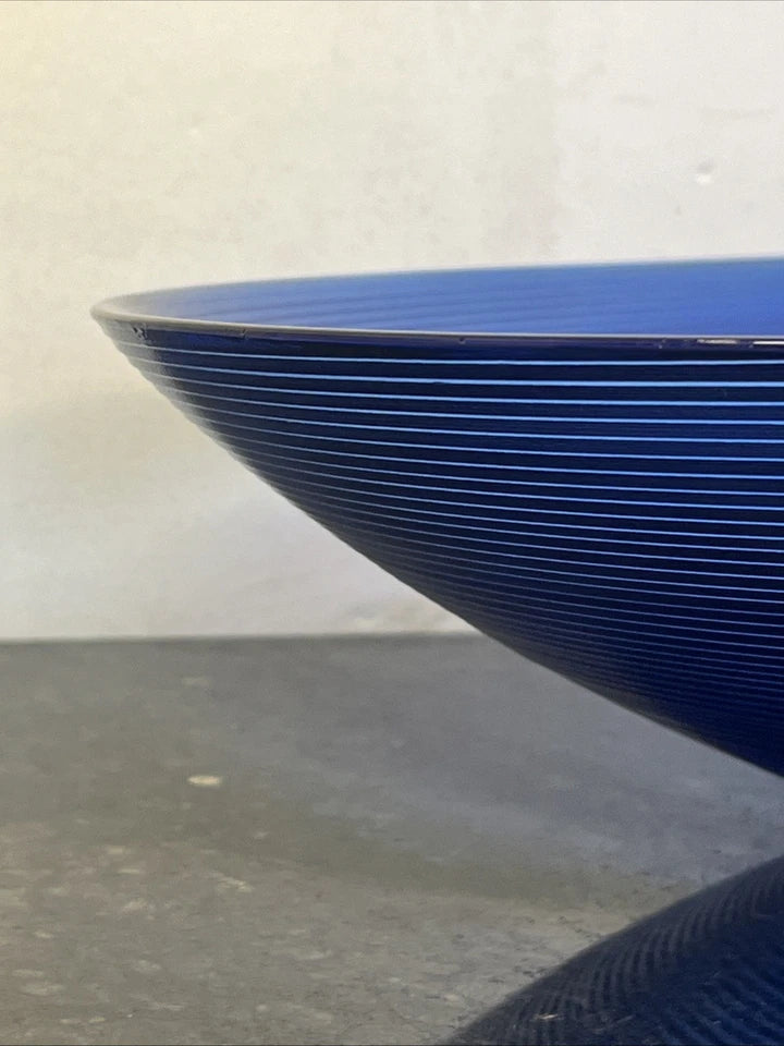 Second view showing the profile of the blue ribbed glass bowl