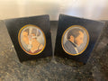 Pair of vintage portrait miniatures in black frames with gilt oval surrounds