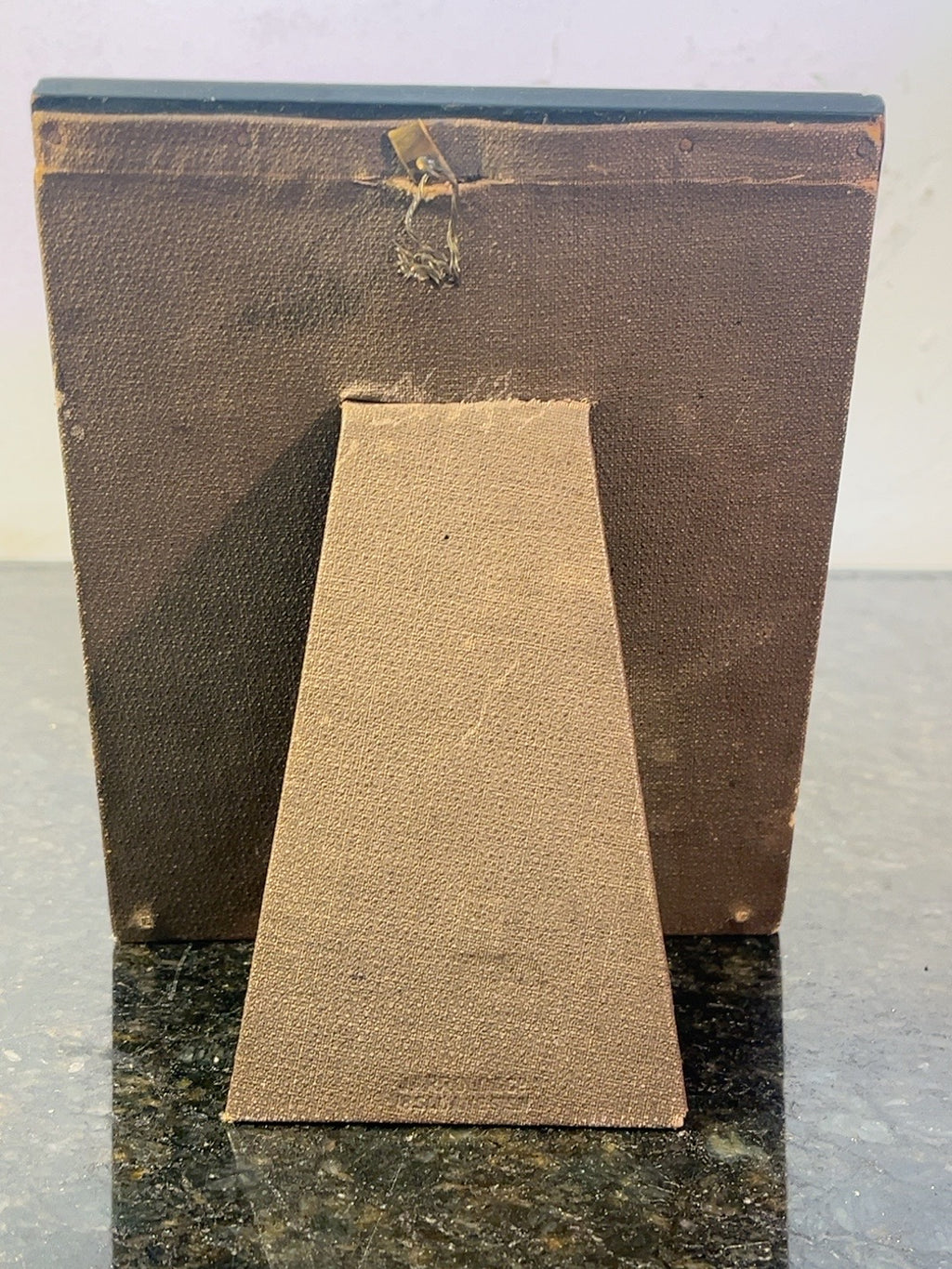 Rear view of a portrait miniature frame showing its easel support