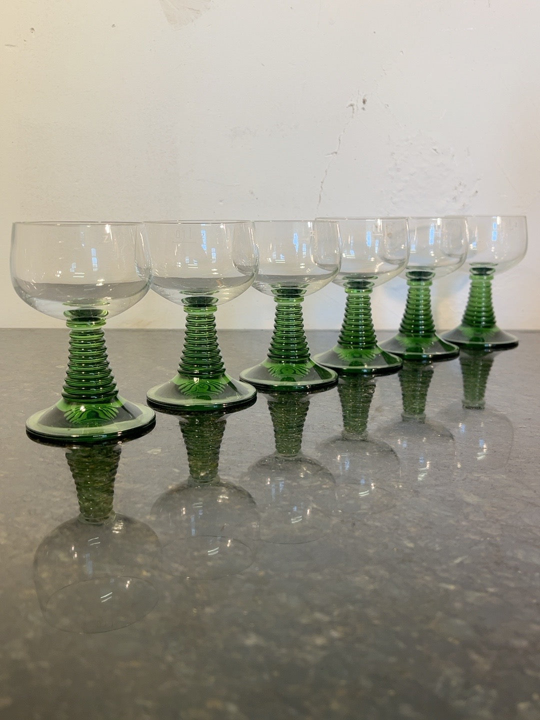 Original set of six Roemer green beehive stem hock glasses photographed on stone