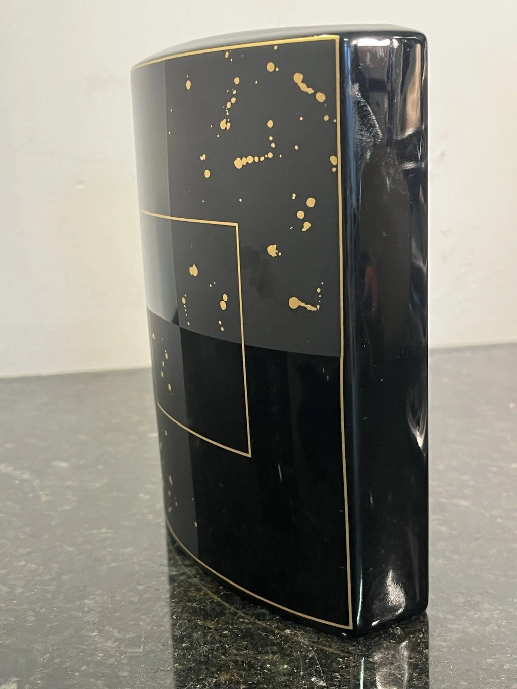 Side profile showing the flattened form and gold trim of the Rosenthal vase