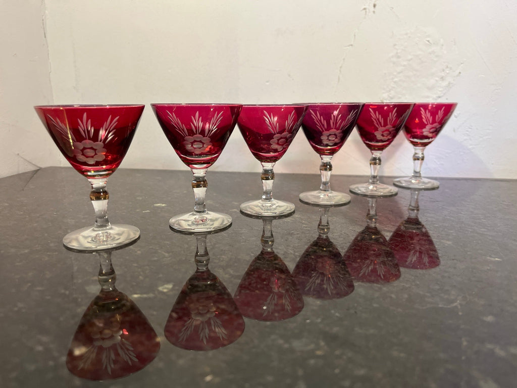 Six ruby red floral stemmed cocktail glasses shown together