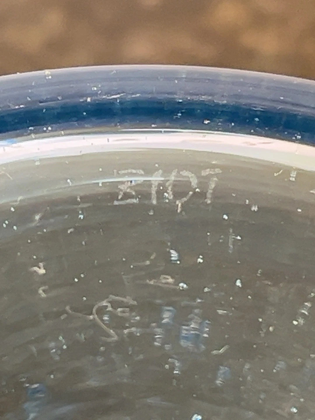 Close view of the Biot signature on the blue glass rim
