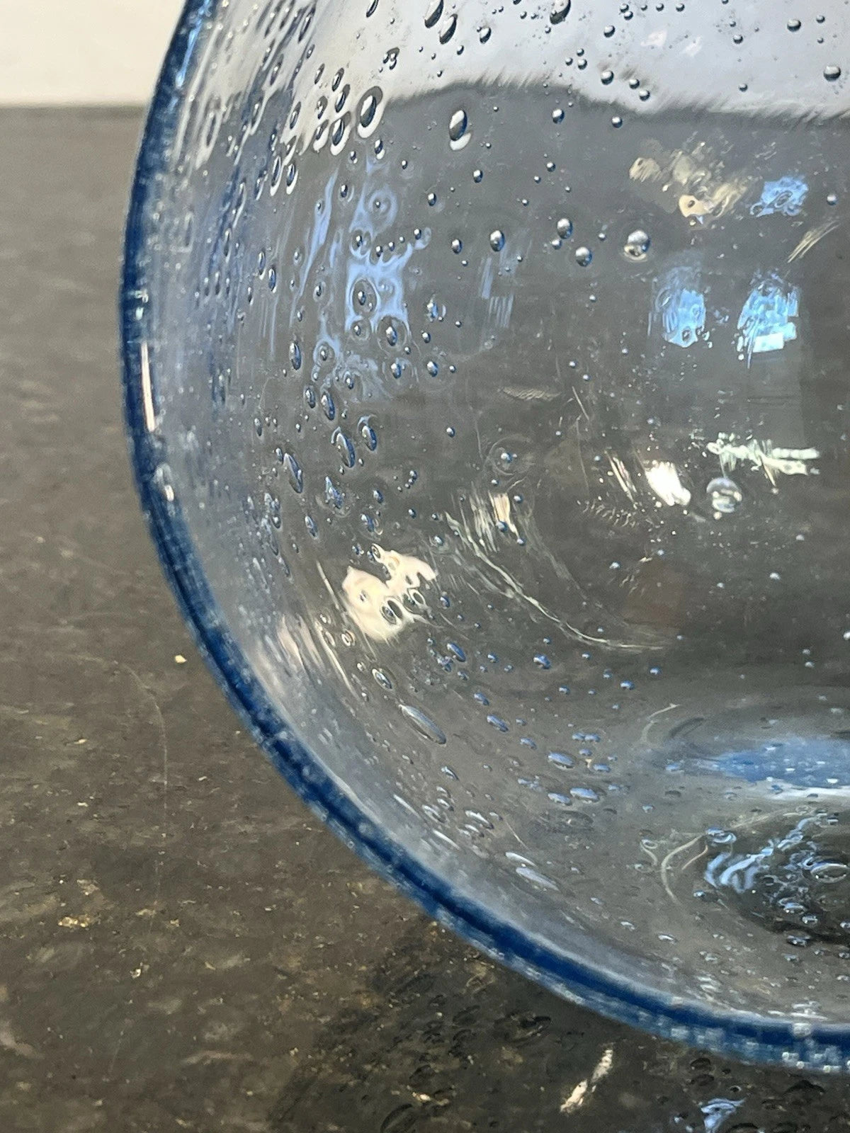 Side view of the rounded blue bubble-glass bowl
