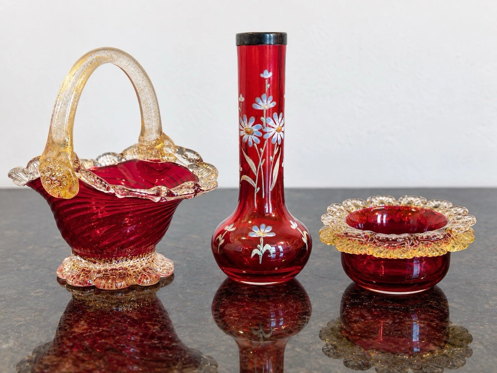 Cranberry art-glass trio showing the basket, floral bud vase and scalloped bowl