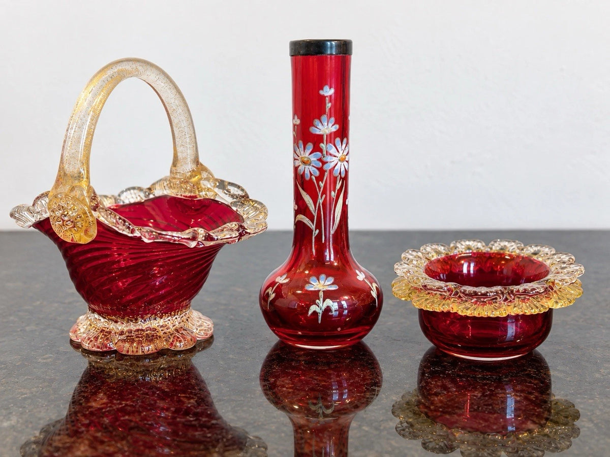 Cranberry art-glass trio showing the basket, floral bud vase and scalloped bowl