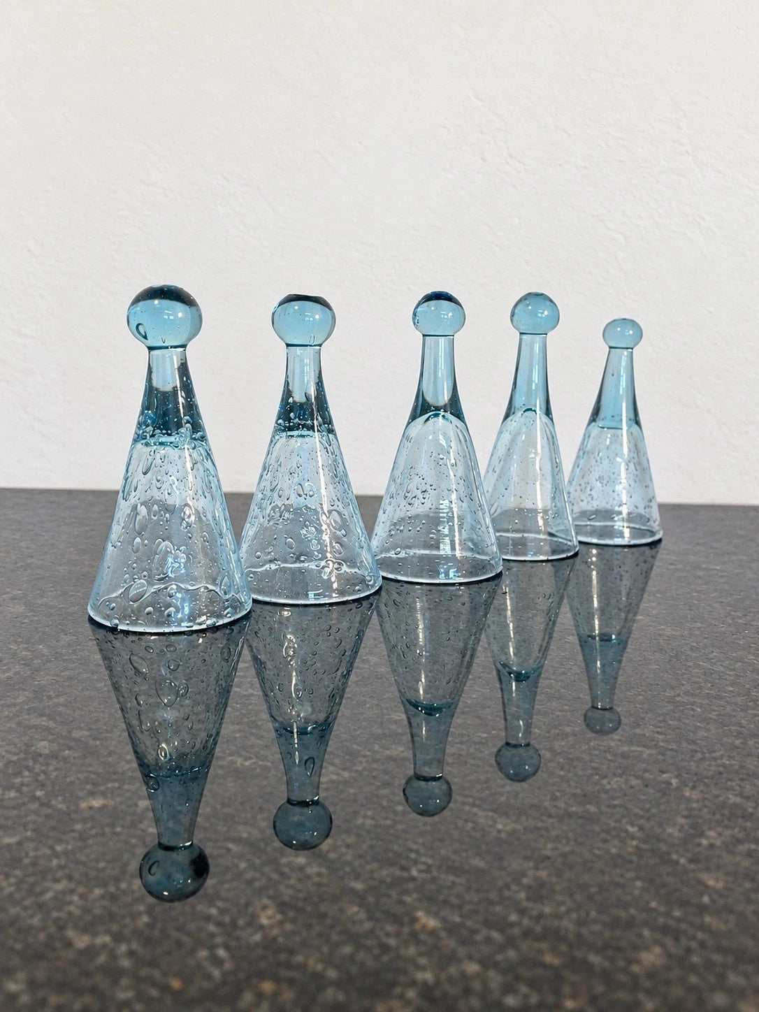 Full view of five Biot bubble glass liquor pomponnettes