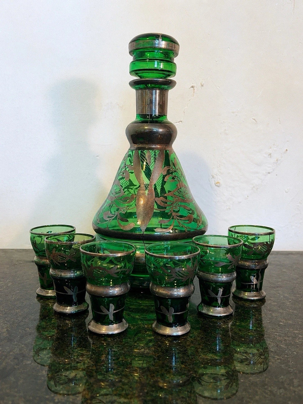 Full view of green glass liqueur decanter and six glasses