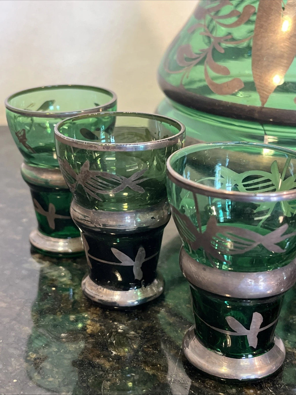 Detail of green glass and metallic floral overlay