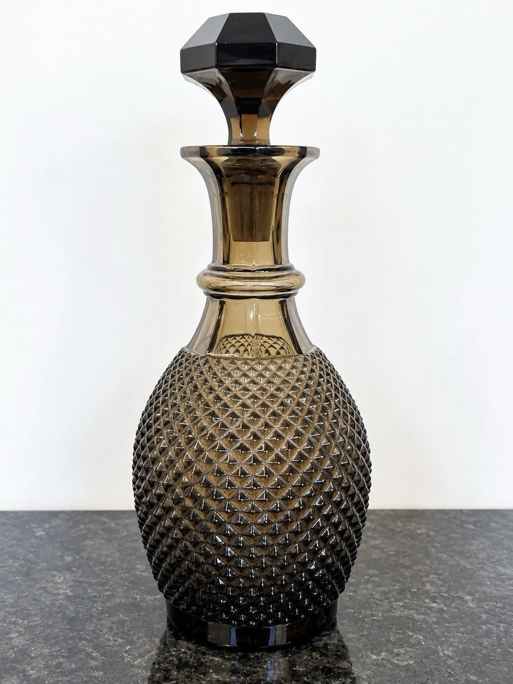 Full view of smoky grey cut crystal decanter with stopper