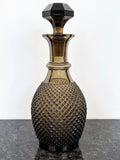 Full view of smoky grey cut crystal decanter with stopper
