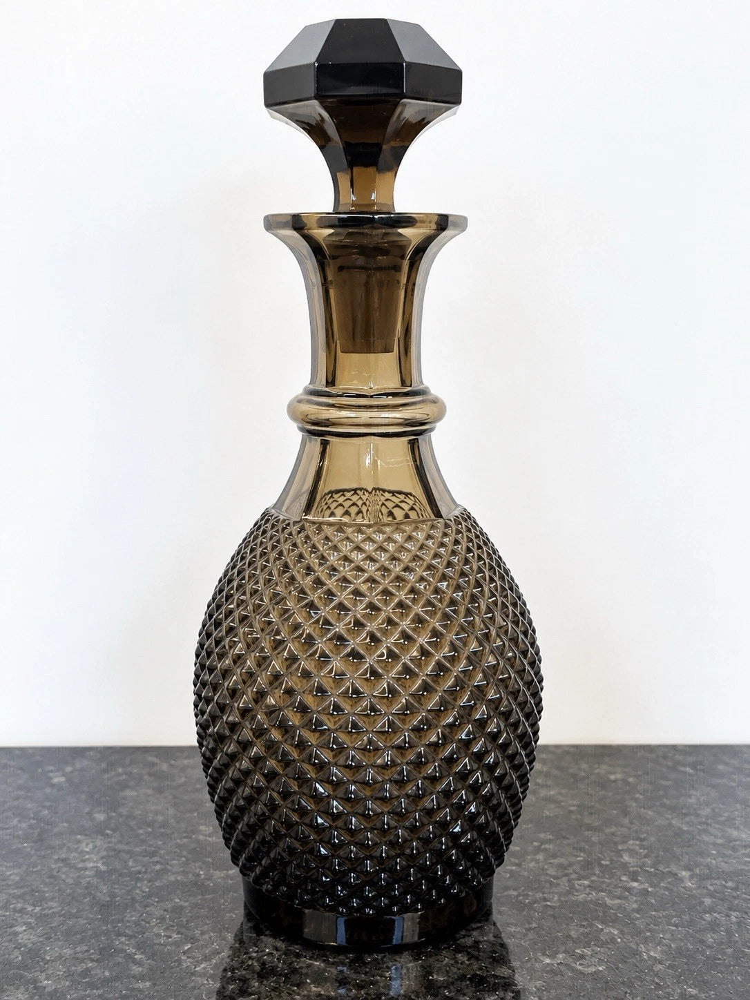Full view of smoky grey cut crystal decanter with stopper