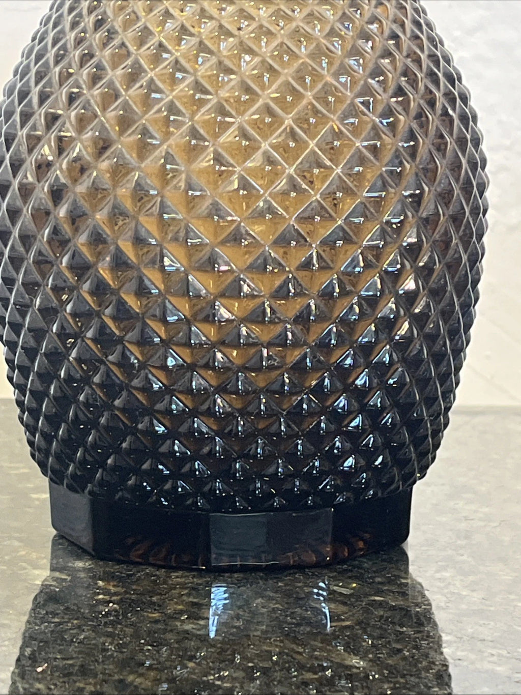 Side view of smoky grey diamond-cut decanter