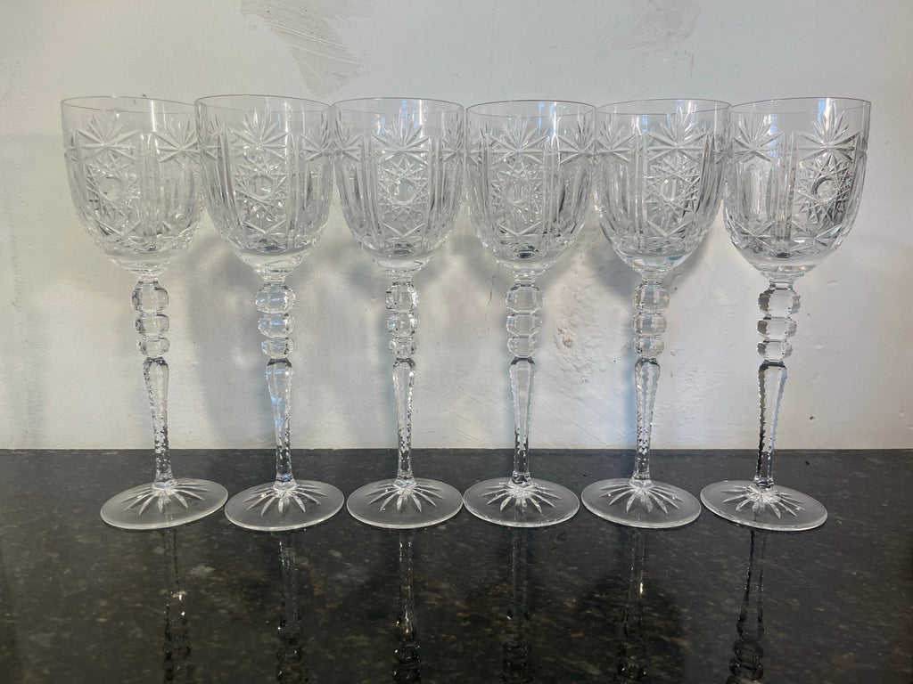 Original set of six tall cut crystal hock glasses photographed together on dark stone